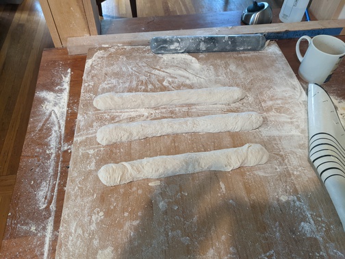 3 dough snakes on a flour board