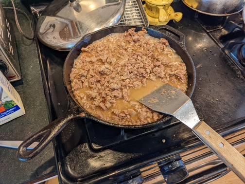 Cast Iron Skillet with meat filling being cooked
